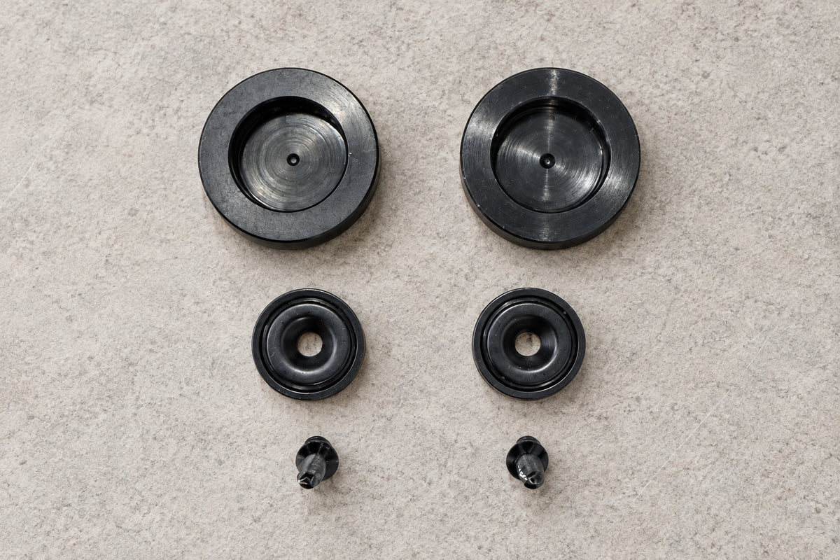 Two large magnetic pucks, two matching circular attachments and two mounting screws.